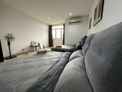 a living room with a large couch in the middle of it at Wonderful Seaview Studio 4Pax 118 Island Plaza in George Town