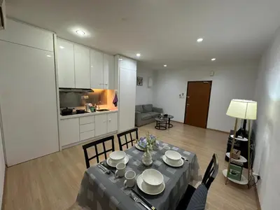 a living room with a table and chairs and a kitchen at Wonderful Seaview Studio 4Pax 118 Island Plaza in George Town