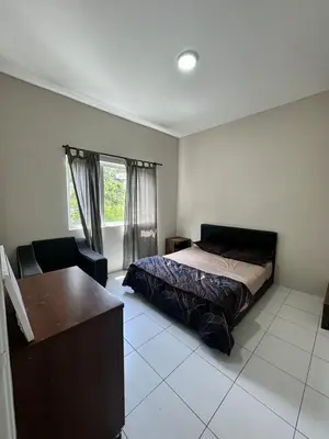 a bedroom with a bed and a desk in it at AYAAN SOCCER HOME at Quintet Apartment with Free Parking in Tanah Rata
