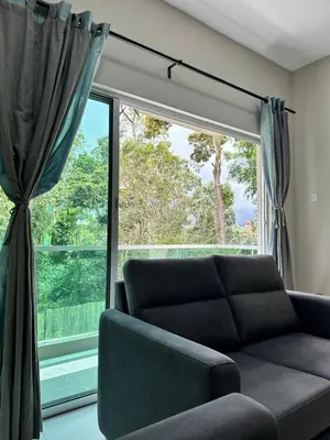 a living room with a couch and a large window at AYAAN SOCCER HOME at Quintet Apartment with Free Parking in Tanah Rata