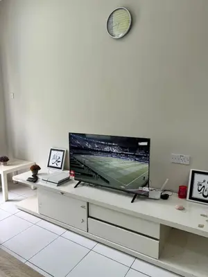 a living room with a large flat screen tv at AYAAN SOCCER HOME at Quintet Apartment with Free Parking in Tanah Rata