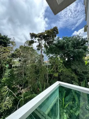 a view from the balcony of a house with trees at AYAAN SOCCER HOME at Quintet Apartment with Free Parking in Tanah Rata