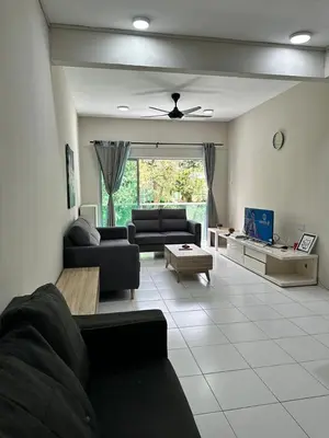 a living room with a couch and a table at AYAAN SOCCER HOME at Quintet Apartment with Free Parking in Tanah Rata