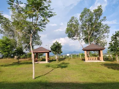 a park with two gazebos in the grass at Starhill Lake Retreat in Lahat