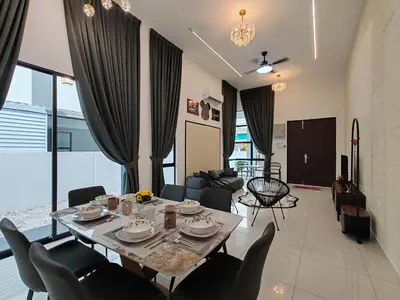 a dining room and living room with a table and chairs at Starhill Lake Retreat in Lahat