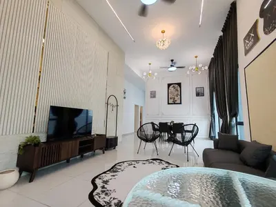 a living room with a tv and a couch and a table at Starhill Lake Retreat in Lahat