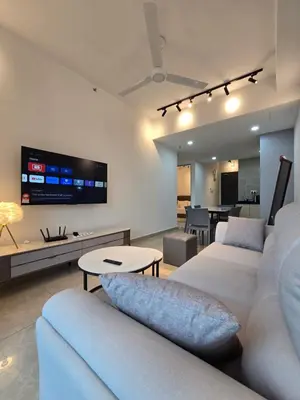 a living room with two white couches and a tv at ICC Premium Executive Suite - Ipoh in Ipoh