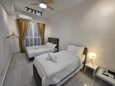 a bedroom with two beds and a ceiling fan at ICC Premium Executive Suite - Ipoh in Ipoh