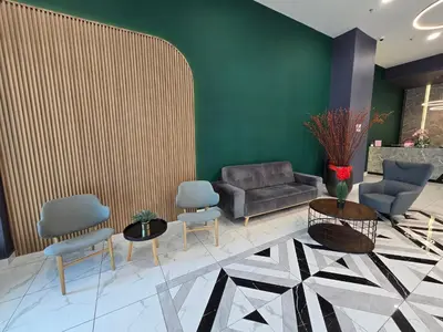 a lobby with a couch and two chairs and a table at ICC Premium Executive Suite - Ipoh in Ipoh