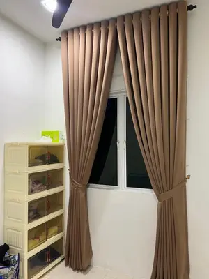 a window with brown curtains in a room at Puteri Resident In Stay in Sungai Petani