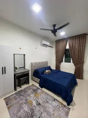 a bedroom with a blue bed and a mirror at Puteri Resident In Stay in Sungai Petani