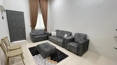 a living room with a couch and two chairs at Puteri Resident In Stay in Sungai Petani