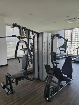 a gym with treadmills and ellipticals in a building at ICC Ipoh Bond Suites by Merveille Louise in Ipoh