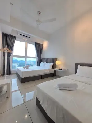 a bedroom with two beds and a large window at ICC Ipoh Bond Suites by Merveille Louise in Ipoh