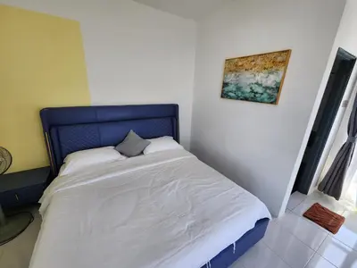 a bed with a blue headboard in a bedroom at Cameron Highland 910 The Garden 3BR 6 Pax in Brinchang