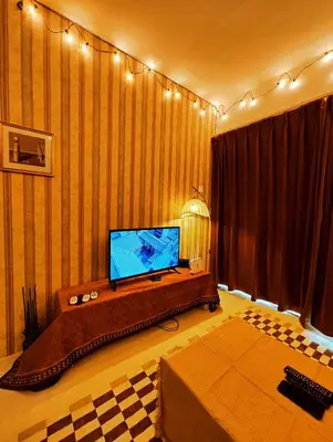 a living room with a flat screen tv on a wall at Cameron Highland 623 London style 10pax in Brinchang