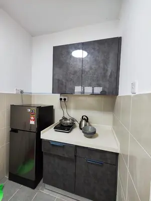 a kitchen with a stove and a refrigerator at Cameron Highland 623 London style 10pax in Brinchang