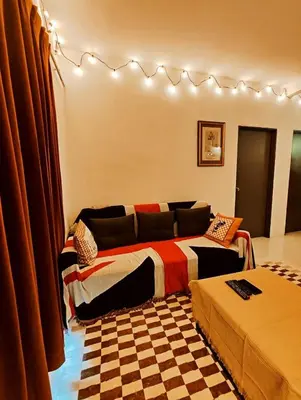 a bedroom with a bed and a checkered floor at Cameron Highland 623 London style 10pax in Brinchang