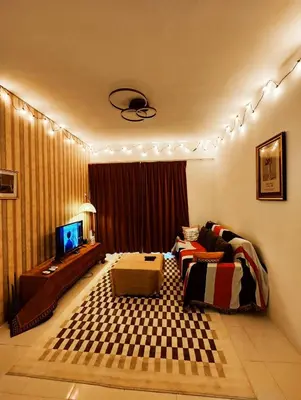 a living room with a couch and a television at Cameron Highland 623 London style 10pax in Brinchang