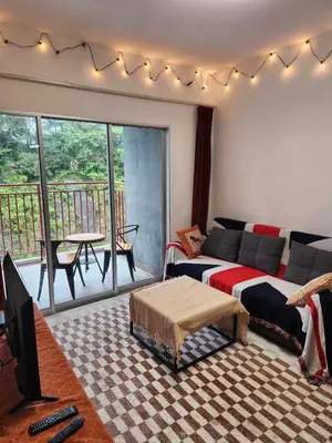 a living room with a couch and a tv and a balcony at Cameron Highland 623 London style 10pax in Brinchang