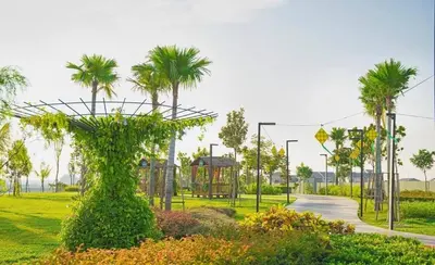 a park with a playground and palm trees at Executive White Houze in Kepala Batas