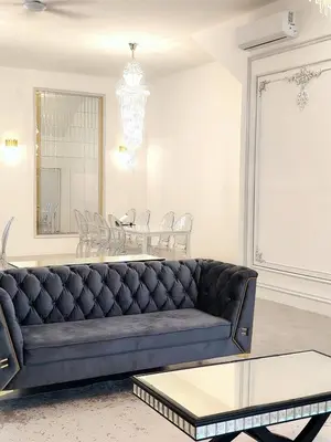 a living room with a couch and a table at Executive White Houze in Kepala Batas