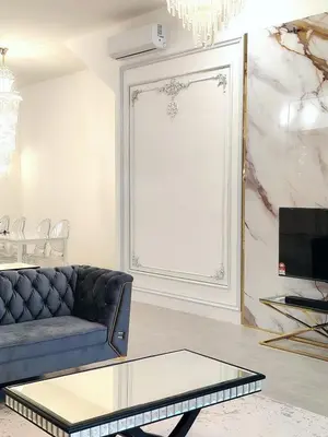a living room with a couch and a window at Executive White Houze in Kepala Batas