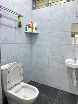 a bathroom with a toilet and a sink at 3 Bedrooms Single Storey Terrace at Taman Inderawasih ,12mins to Penang Bridge , 5mins to Sunway Carnival Mall in Butterworth
