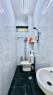 a white bathroom with a sink and a toilet at 3 Bedrooms Single Storey Terrace at Taman Inderawasih ,12mins to Penang Bridge , 5mins to Sunway Carnival Mall in Butterworth