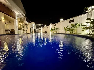an empty swimming pool in a building at night at Botani Pool Villa 5R4B 14pax Karaoke BBq in Ipoh