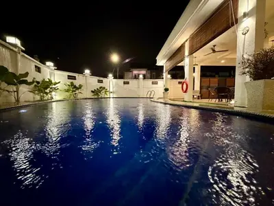 a swimming pool in the middle of a building at night at Botani Pool Villa 5R4B 14pax Karaoke BBq in Ipoh