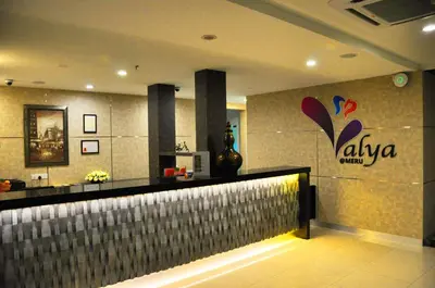 a bar in a restaurant with a sign on the wall at Valya Hotel, Ipoh in Ipoh