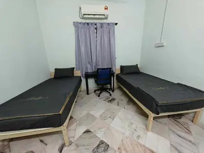 a room with two beds and a chair at Be Stay Ipoh with parking - 14pax, 5Rooms in Ipoh