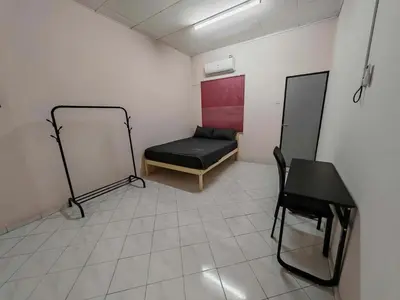 a room with a bed and a chair in it at Be Stay Ipoh with parking - 14pax, 5Rooms in Ipoh