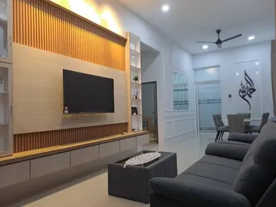 a living room with a flat screen tv on a wall at Tiara Homestay Bandar Baru Kuala Lipis in Kuala Lipis