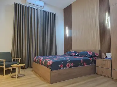 a bedroom with a bed and a chair at Tiara Homestay Bandar Baru Kuala Lipis in Kuala Lipis