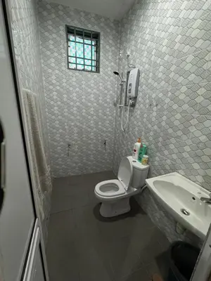 a bathroom with a toilet and a sink at Teratak Perdana in Sungai Petani