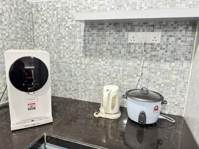 a kitchen counter with a toaster and a slow cooker at Teratak Perdana in Sungai Petani
