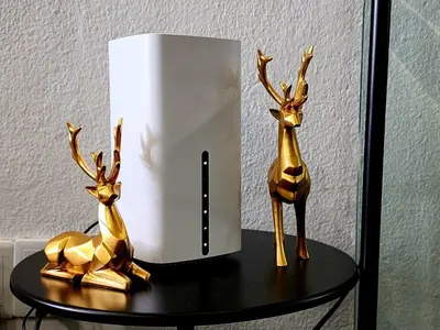 two statues of deer on a table next to a speaker at Georgetown Stay in George Town