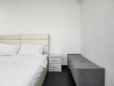 a small bedroom with two beds and a bench at Georgetown Stay in George Town