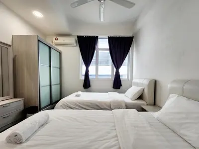 a bedroom with two beds and a window at Georgetown Stay in George Town