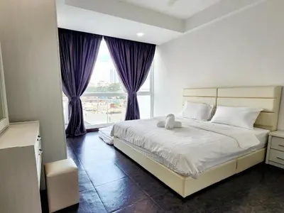 a bedroom with a bed and a large window at Georgetown Stay in George Town