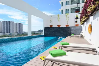 a swimming pool on the roof of a building at Olive Tree Hotel Penang in Bayan Lepas