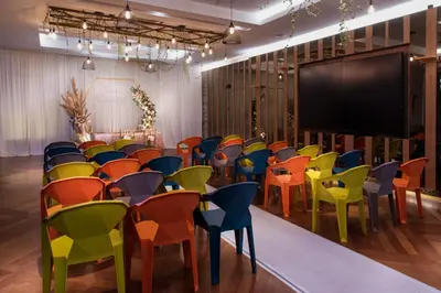 a classroom with colorful chairs and a chalkboard at Olive Tree Hotel Penang in Bayan Lepas