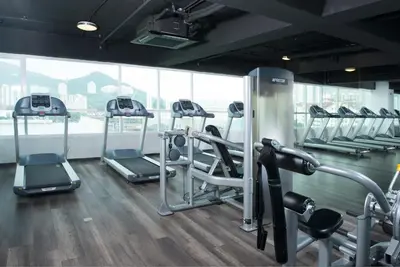 a gym with several tread machines in a room at Olive Tree Hotel Penang in Bayan Lepas