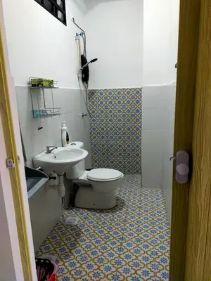 a bathroom with a toilet and a sink at Iskandar SmartStay in Kampong Bota Road