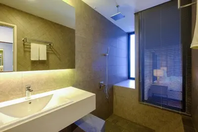 a bathroom with a sink and a mirror at Penang Beachfront Seaview Residences in Tanjong Tokong