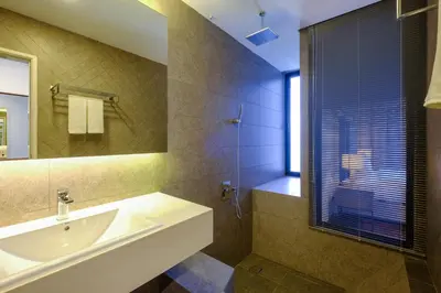 a bathroom with a sink and a mirror at Penang Beachfront Seaview Residences in Tanjong Tokong