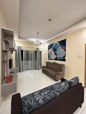 a large living room with a couch and a television at StichStay Cameron in Tanah Rata