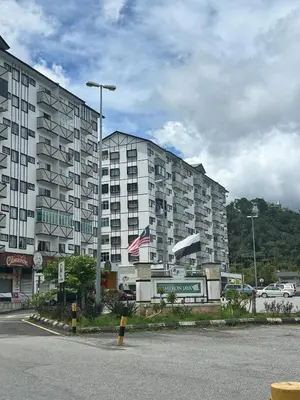 a large apartment building in front of a parking lot at StichStay Cameron in Tanah Rata